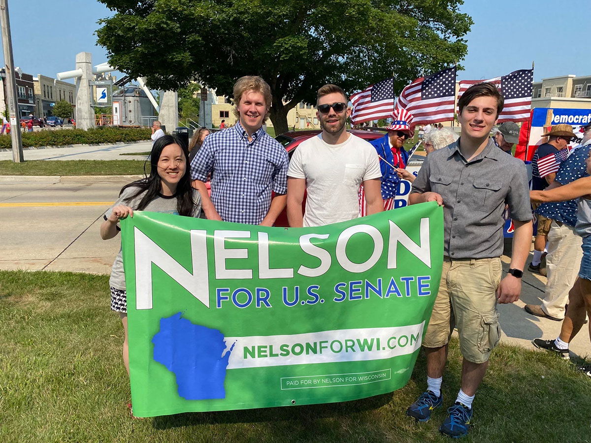 Nelson Campaign volunteers holding banner that states "Nelson for US Senate"